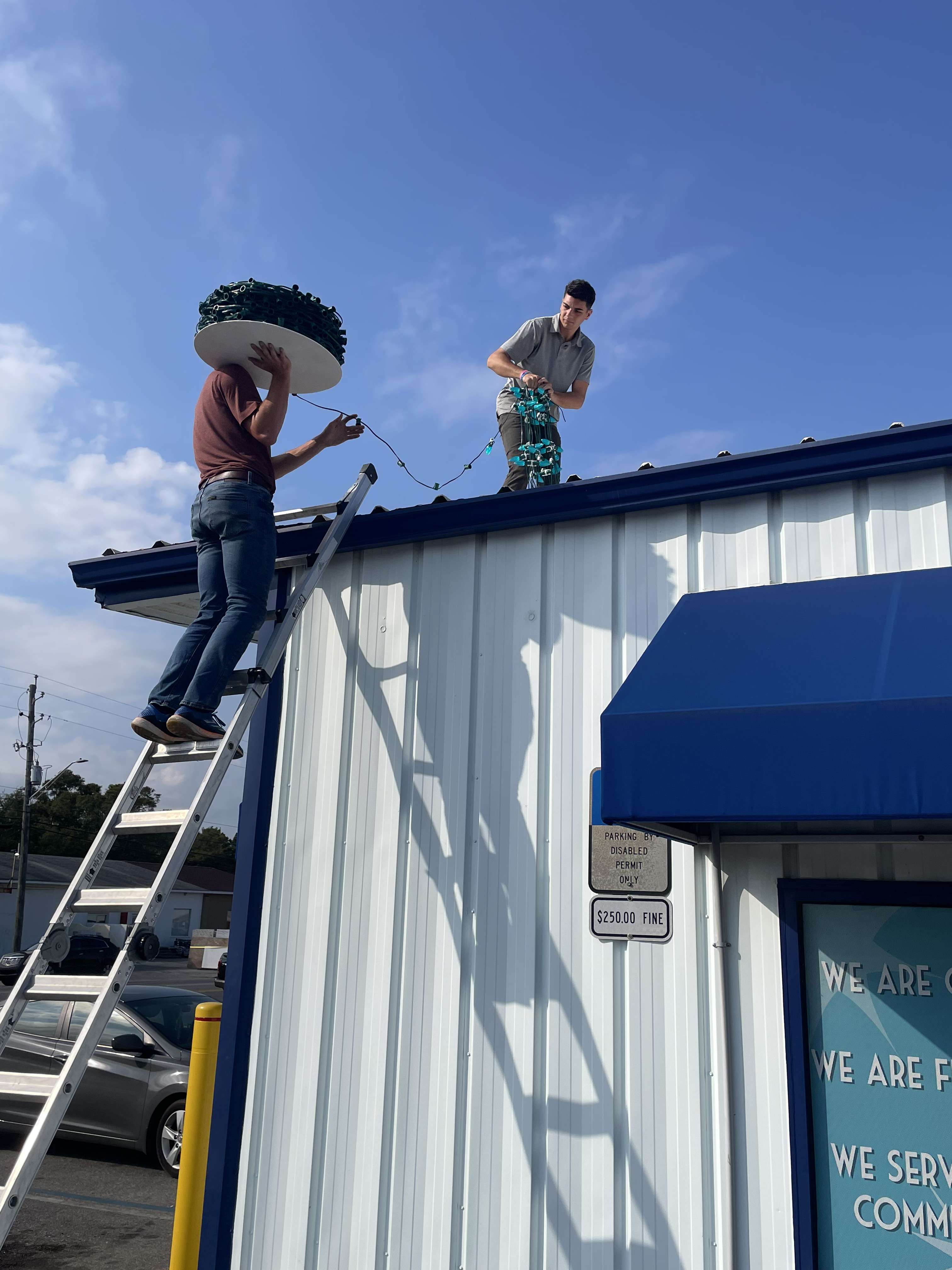 WAHOO! crew installing lights on a Pensacola business