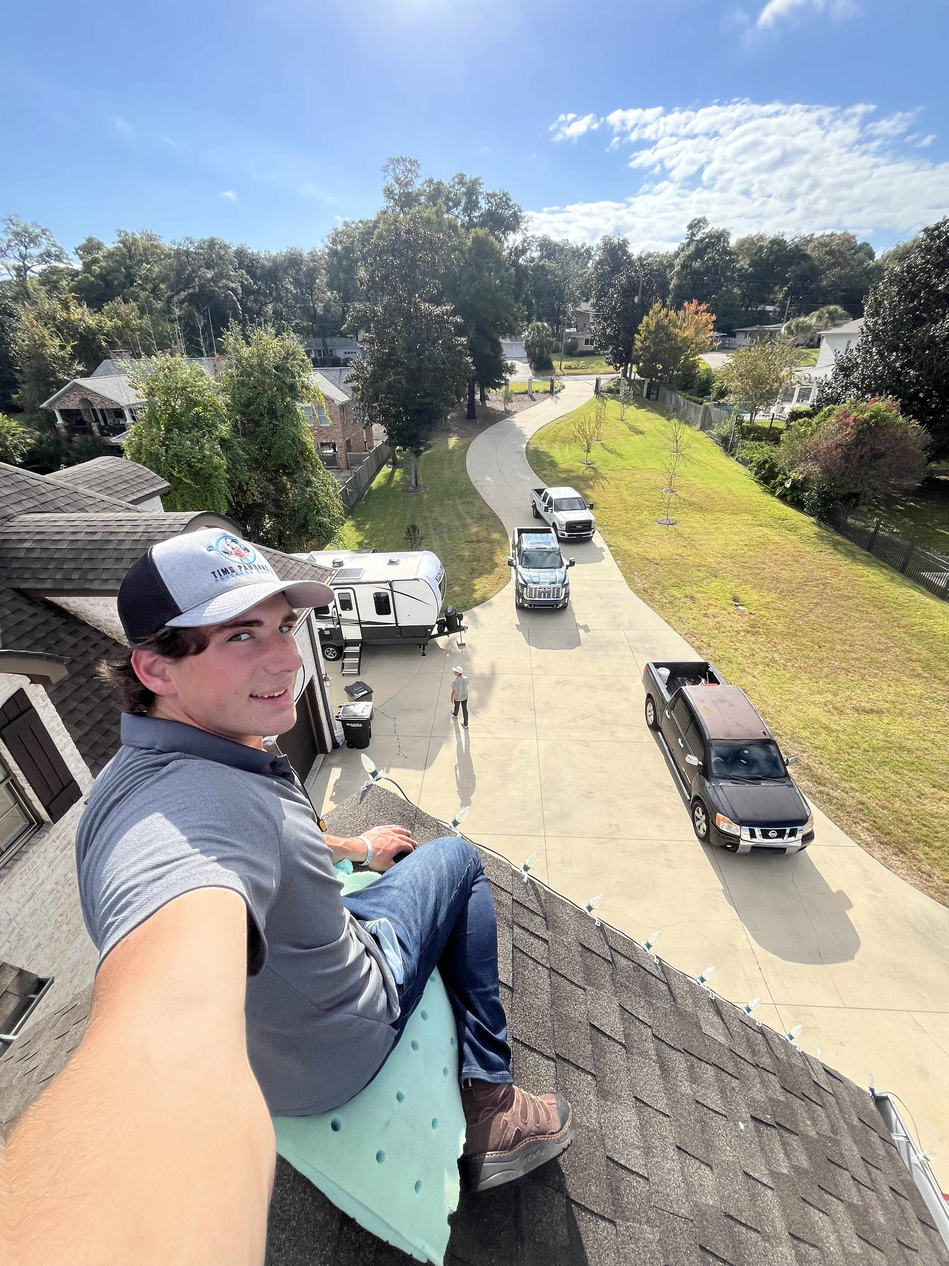 WAHOO! technician on a steep residential roof installing C9 lights
